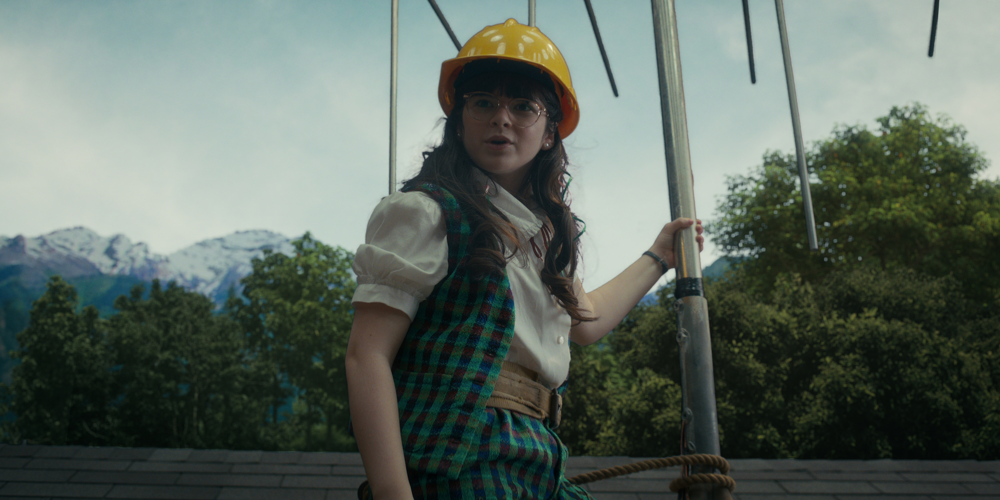 'Stranger Things 4' Suzie, played by Gabriella Pizzolo, standing on top of a roof with an antenna in a production still from the series.