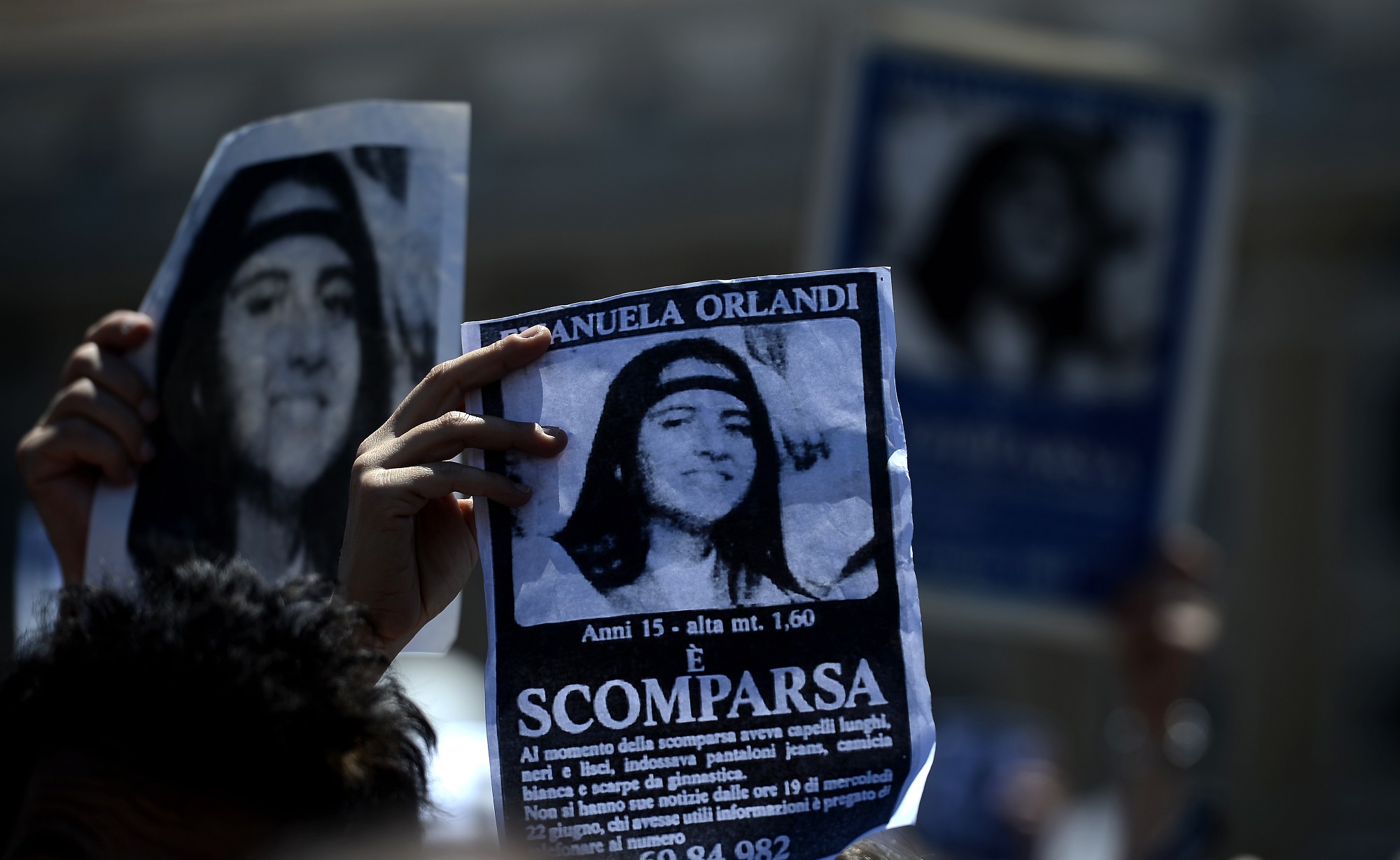 A demonstrator holds a poster of Emanuela Orlandi reading "Missing" during Pope Benedict XVI's Regina Coeli noon prayer in St. Peter's square, at the Vatican on May 27, 2012.