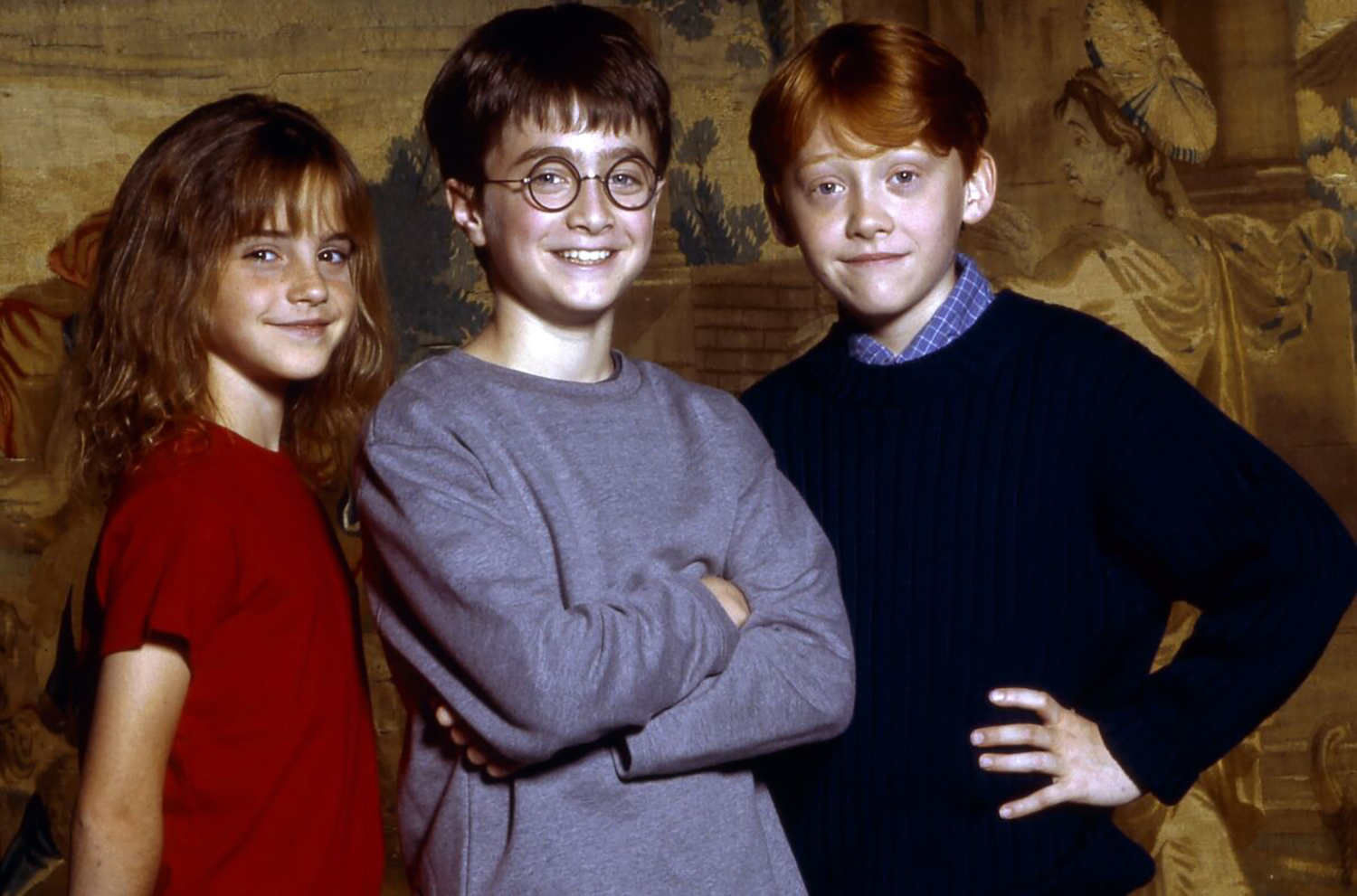 Young Harry Potter movie stars Emma Watson, Daniel Radcliffe, and Rupert Grint smile and pose together