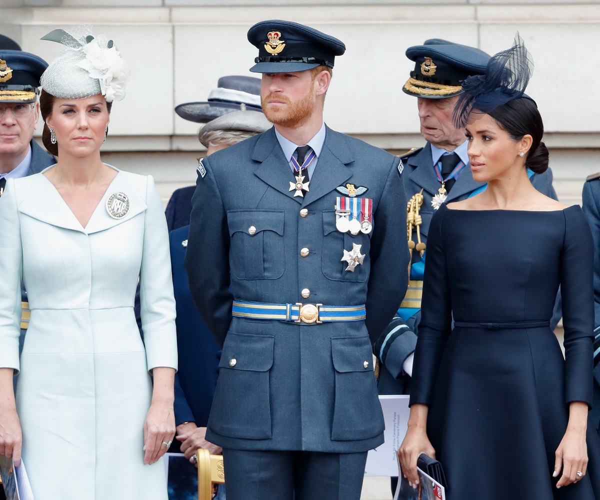 Meghan Markle glaring at Kate Middleton during a ceremony to mark the centenary of the Royal Air Force on the forecourt of Buckingham Palace with Prince Harry