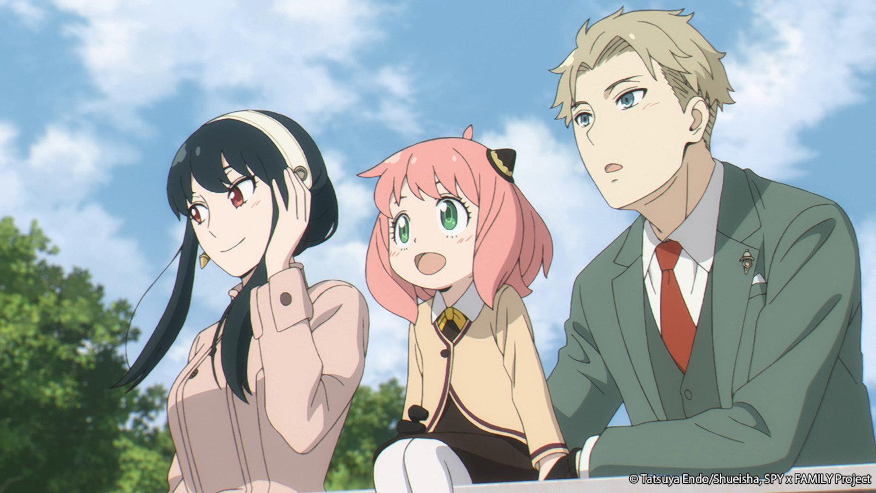 Yor, Anya, and Loid Forger in 'Spy x Family' for our article about season 2. They're leaning over a railing, and there's a blue sky behind them.