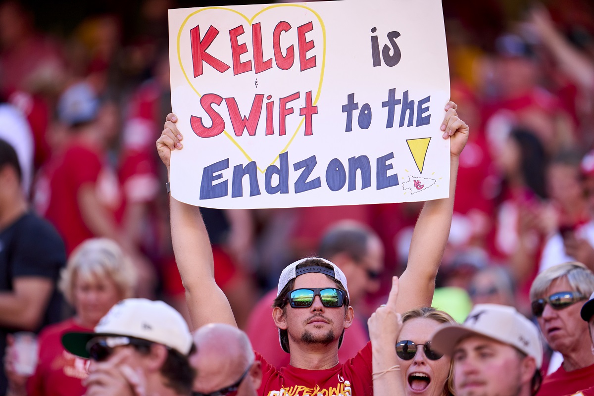 A Kansas City Chiefs fan holds a sign referencing Taylor Swift and Travis Kelce's romance
