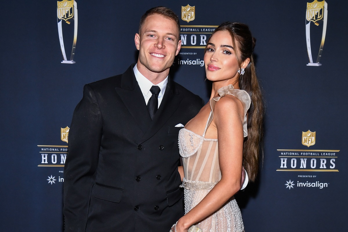 Christian McCaffrey and Olivia Culpo walking on the red carpet at NFL Honors held at Symphony Hall at the Phoenix Convention Center