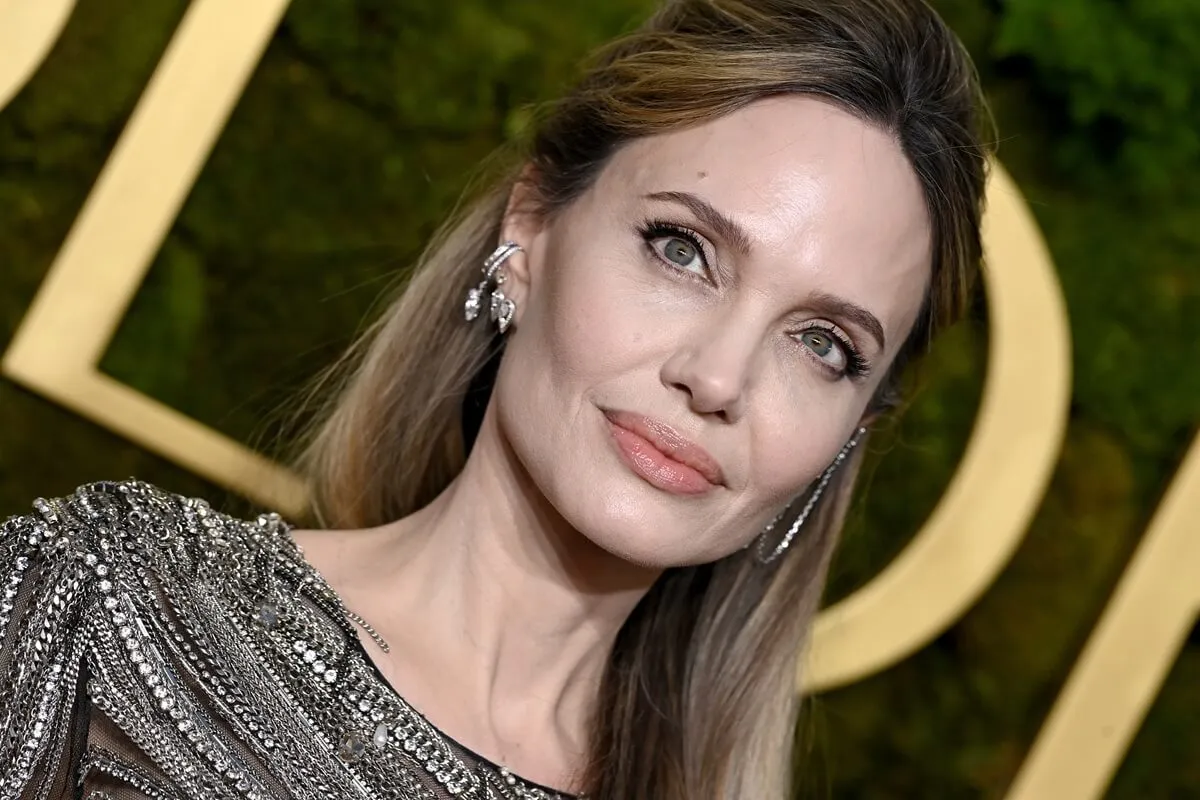 Angelina Jolie posing in a brown dress at the Golden Globes.