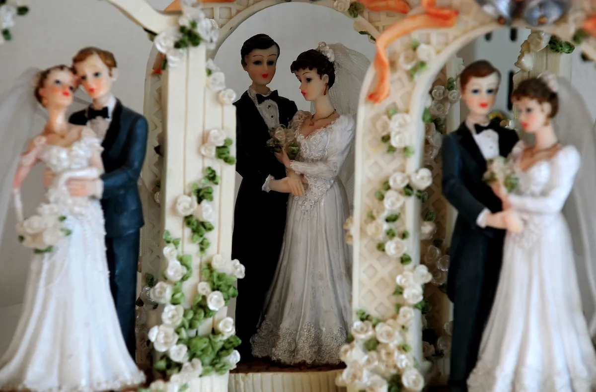 Three bride and groom wedding cake figures