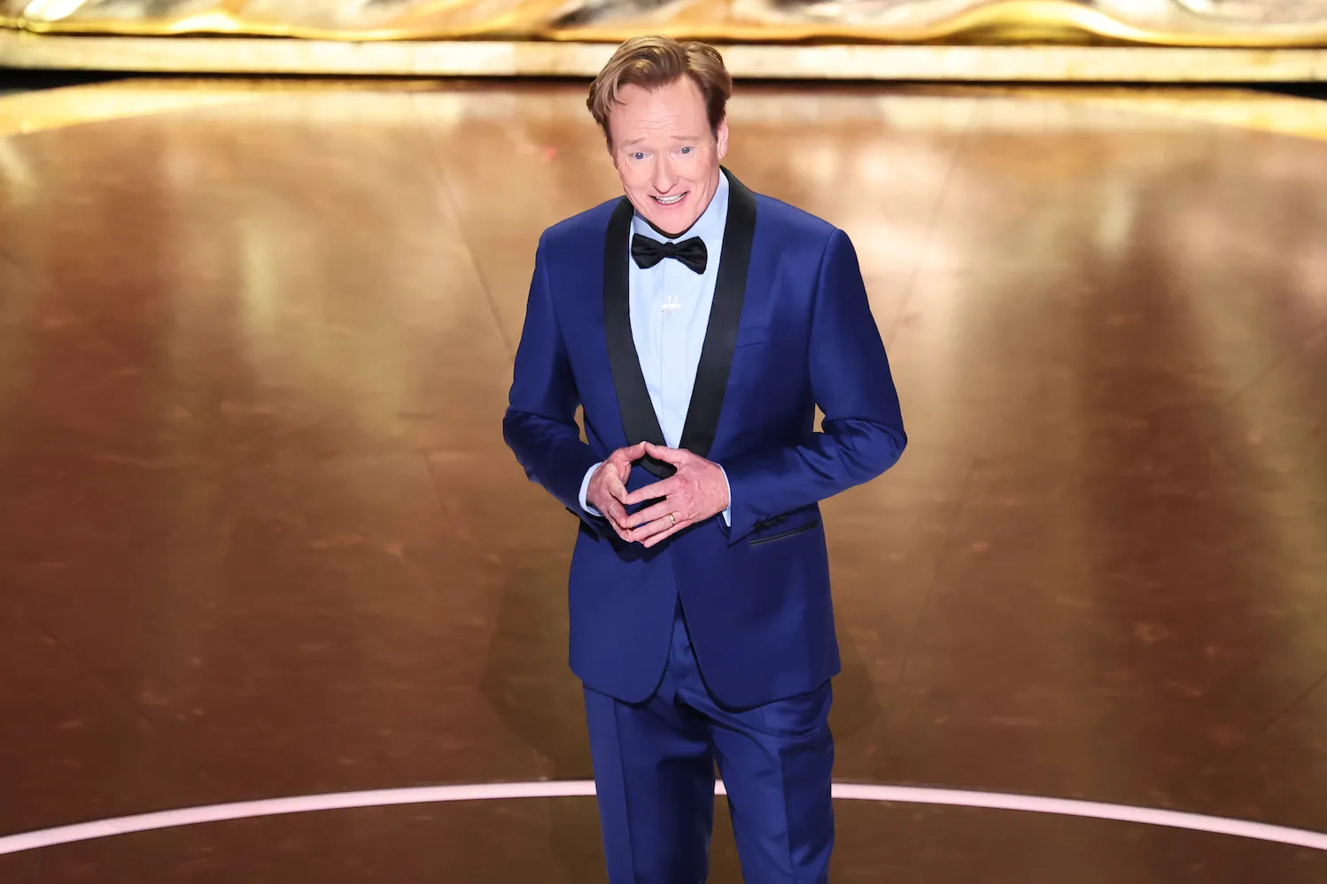 Conan O'Brien wearing a blue tuxedo while on stage during the 97th Annual Academy Awards