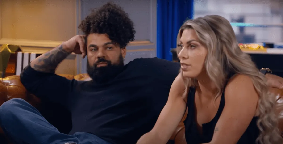 David and Madison sitting on a couch during an episode of 'Married at First Sight' Season 18