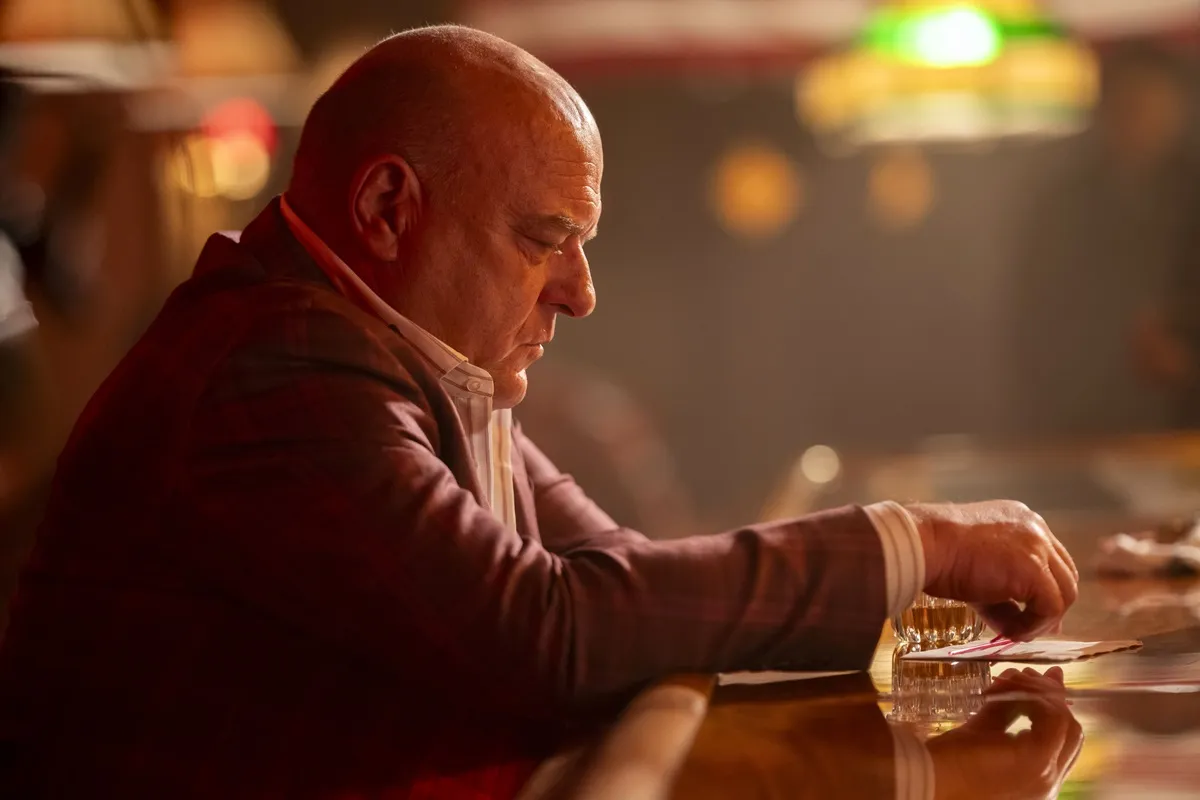 Dean Norris sitting at a bar in an episode of 'Law and Order Organized Crime'.