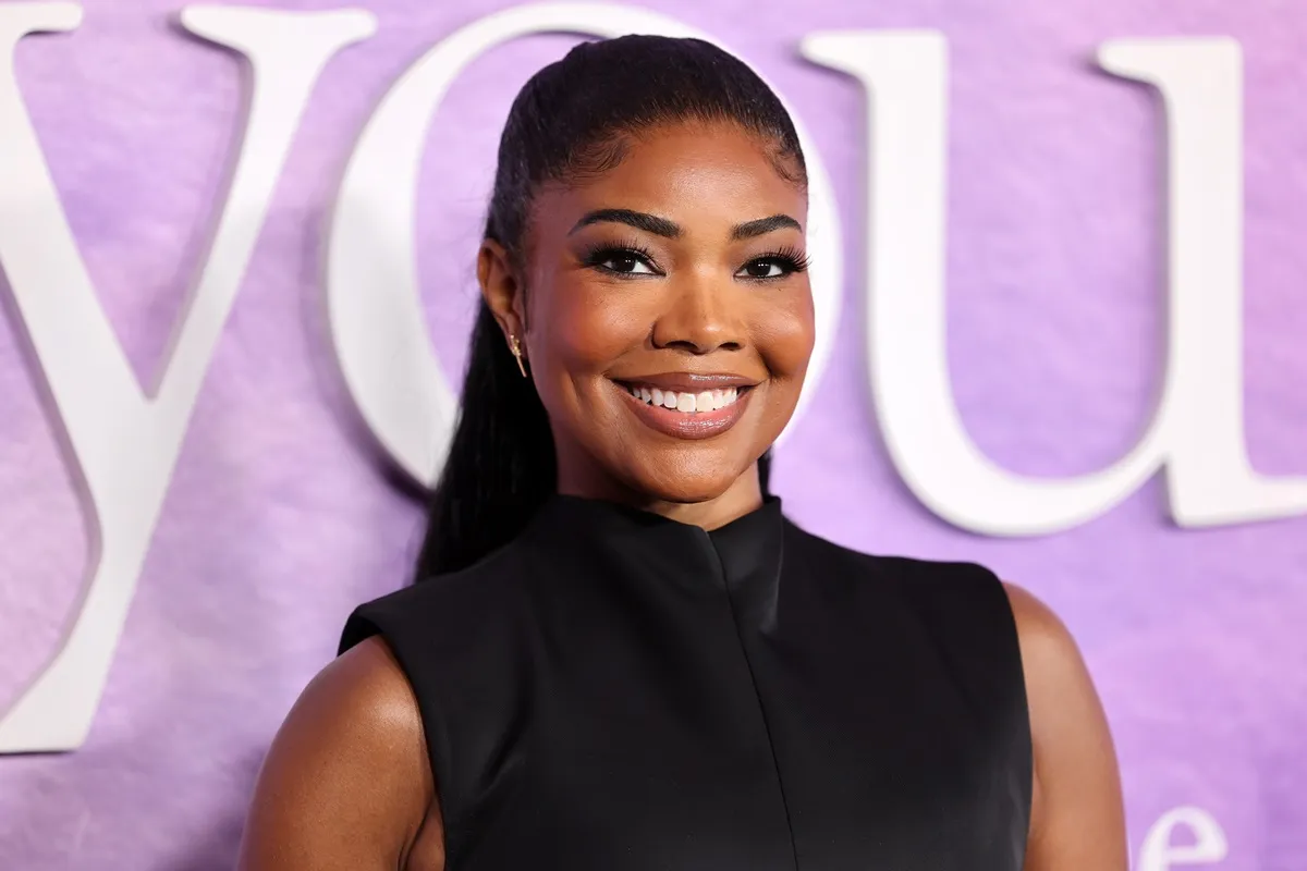 Gabrielle Union posing at 'The Idea of You' movie premiere in a black dress.