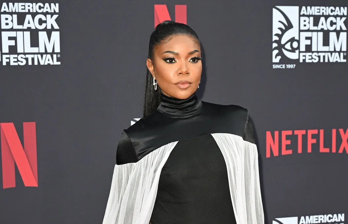 Gabrielle Union posing at 'The Perfect Find' screening in a black and white dress.