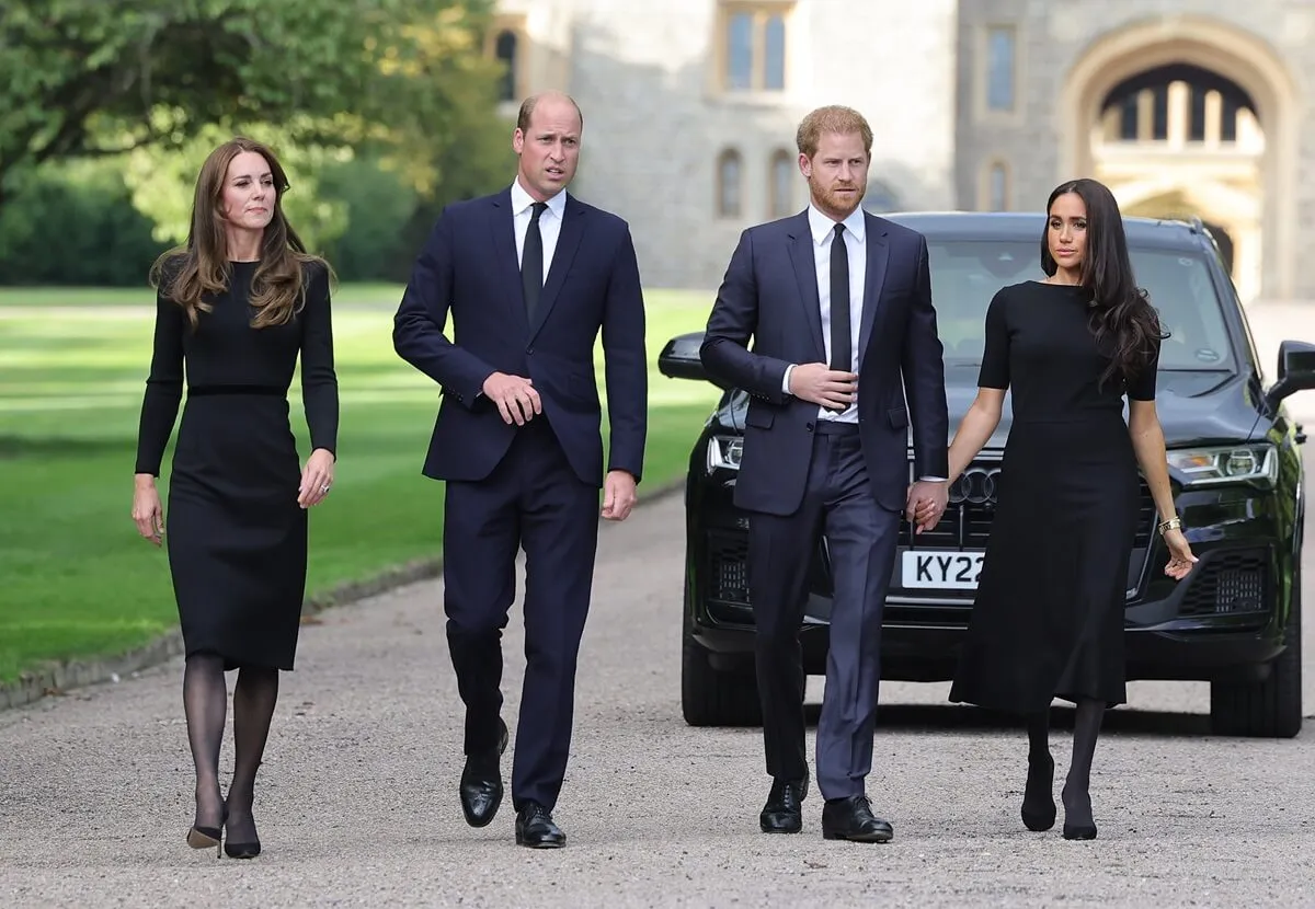 Kate Middleton, Prince William, Prince Harry, and Meghan Markle on the long Walk at Windsor Castle to view flowers and tributes to Queen Elizabeth II