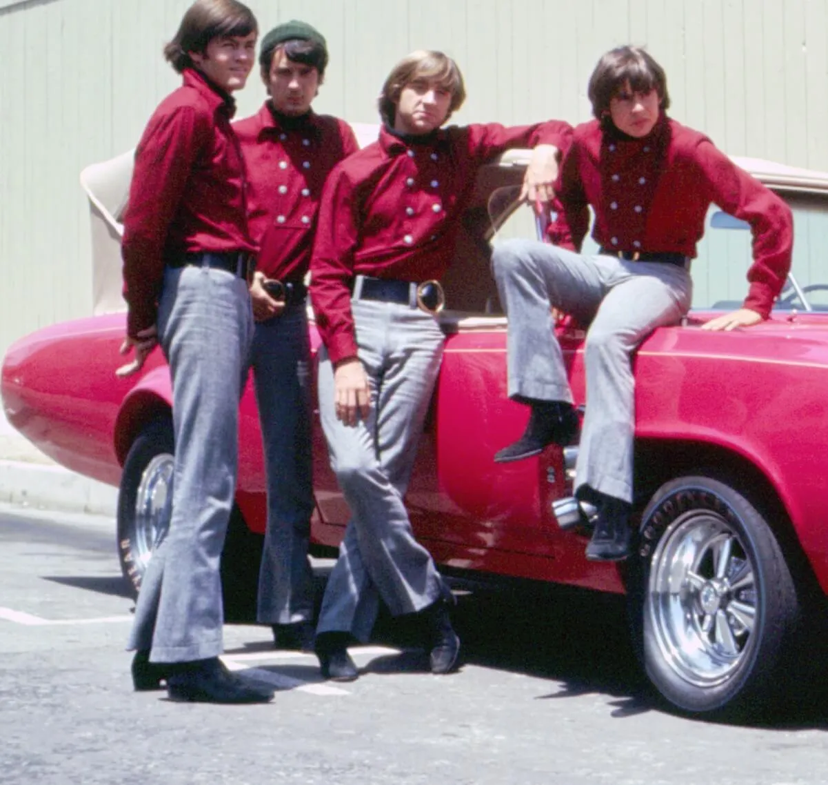 The Monkees with a car